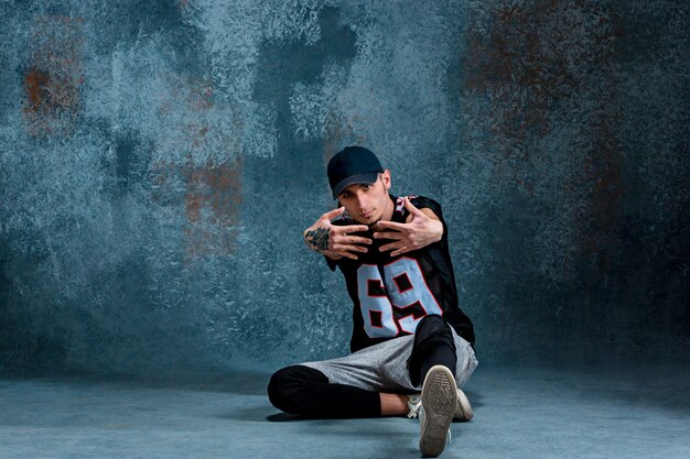 Young man break dancing on wall.