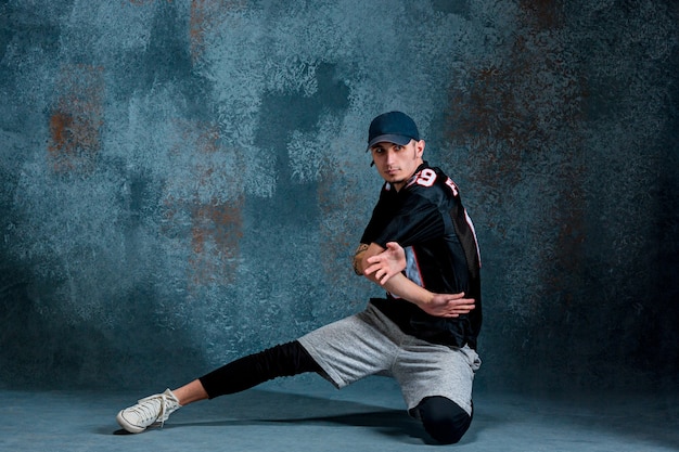 Young man break dancing on wall 