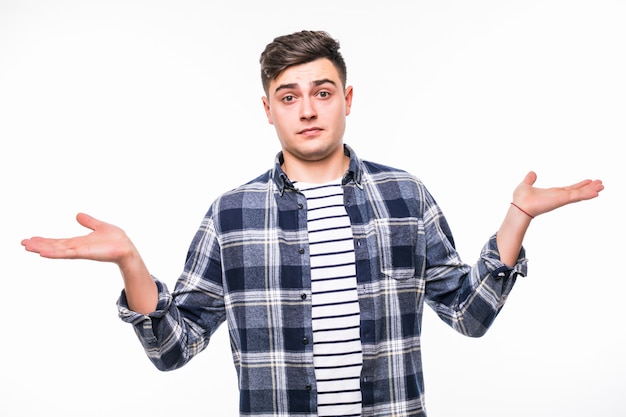 Young man in bright clothes with shocked facial expression isolated over white wall