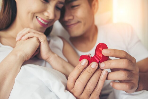 Young man bringing ring box for his girlfriend at his home