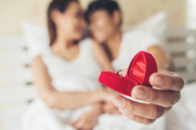 Young man bringing ring box for his girlfriend at his home