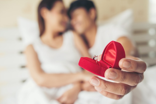 Young man bringing ring box for his girlfriend at his home