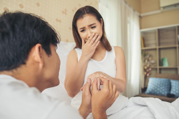 Young man bringing ring box for his girlfriend at his home