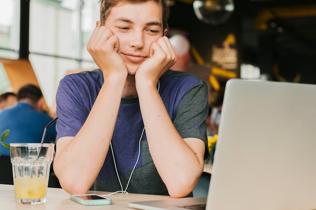 Young man in cafe making videocall