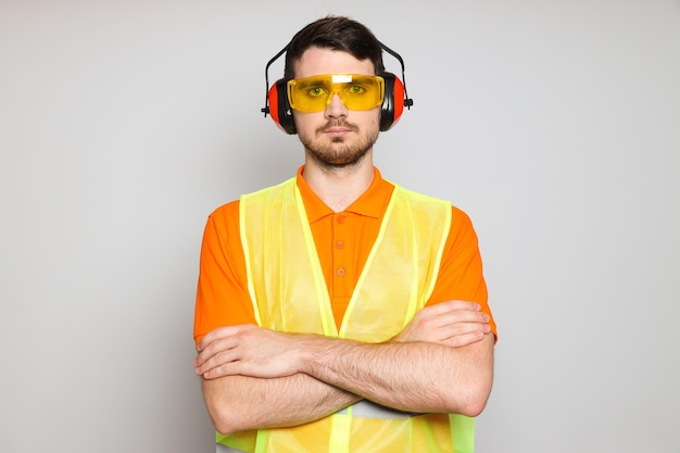 Free photo young man civil engineer in ear protectors
