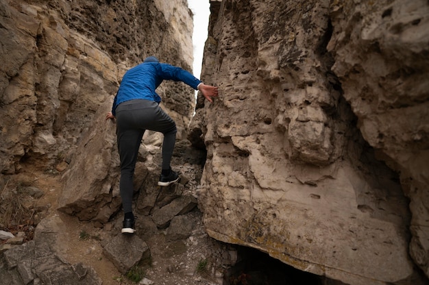 Young man climbing rocks