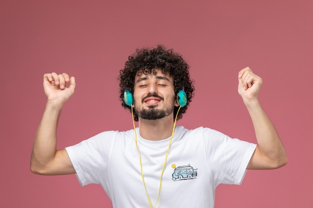 young man closing his eyes and enjoying music