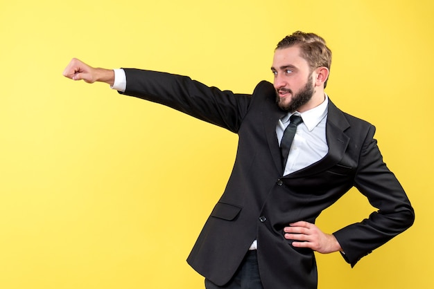 Young man closing his fist pointing something