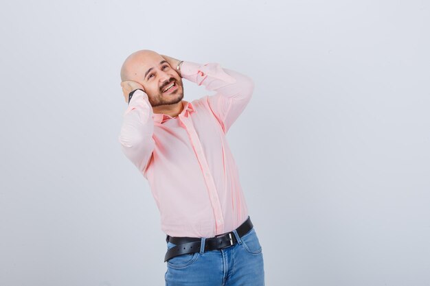 Young man covering ears with hands