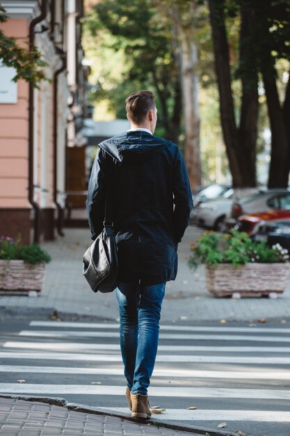 Young man cross the street