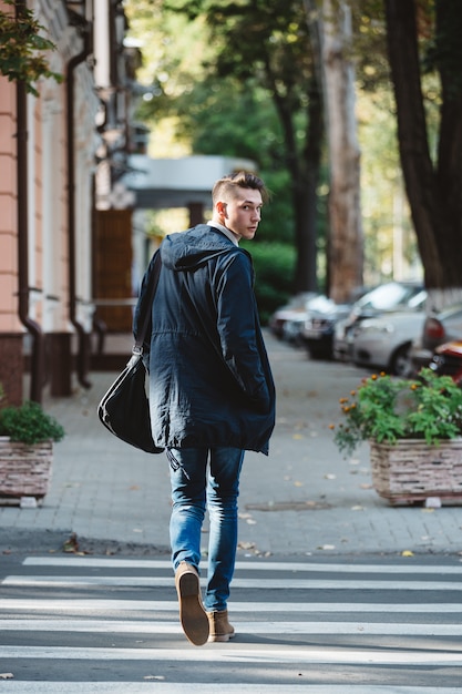 Young man cross the street