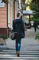 Free photo young man cross the street