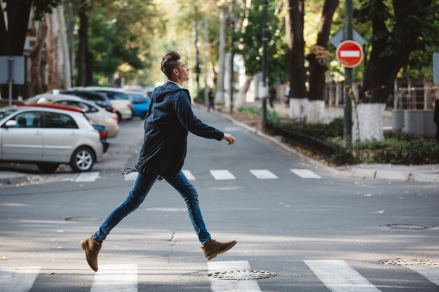 Young man cross the street