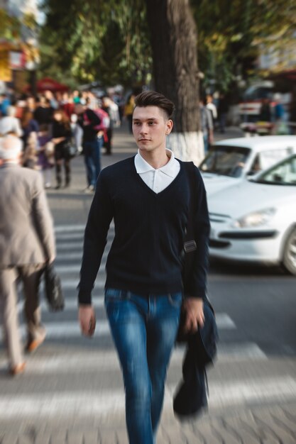 Young man cross the street