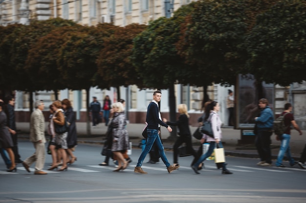 Young man cross the street