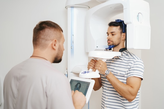 Free photo young man in a dental 3d scanner