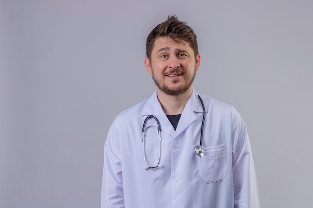 Young man doctor wearing white coat and stethoscope  with smile on face