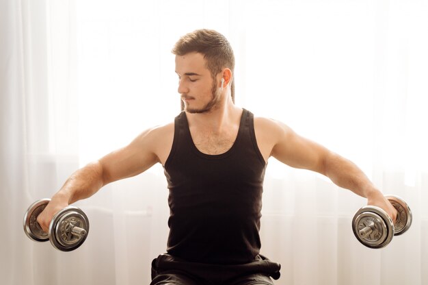 Young man doing fitness exercise at home