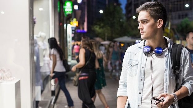 Young man doing window shopping