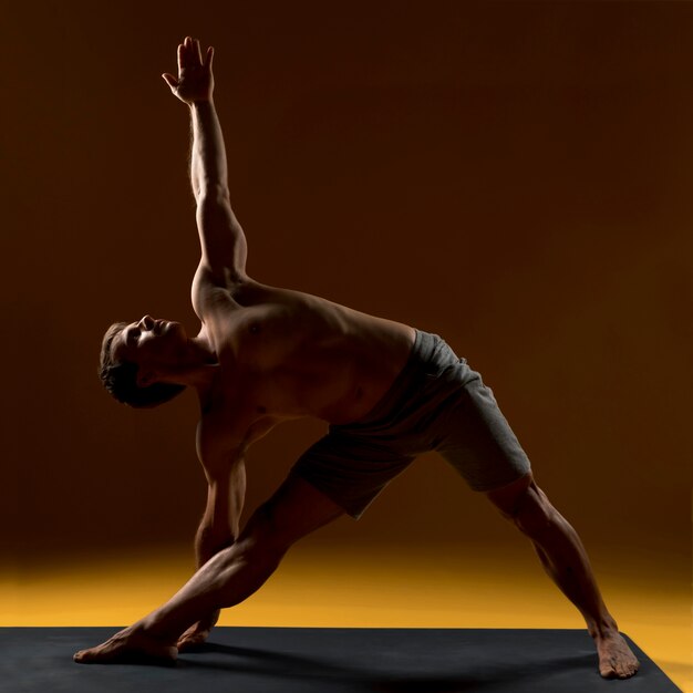 Young man doing yoga exercise