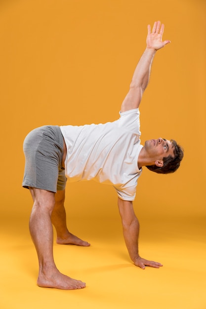 Free photo young man doing yoga pose