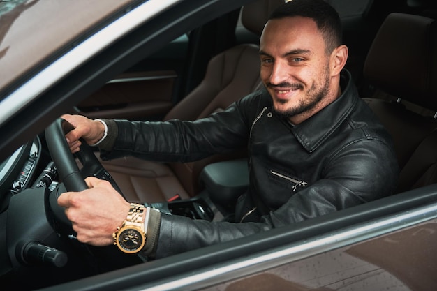 Young man driving modern car