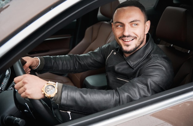 Young man driving modern car