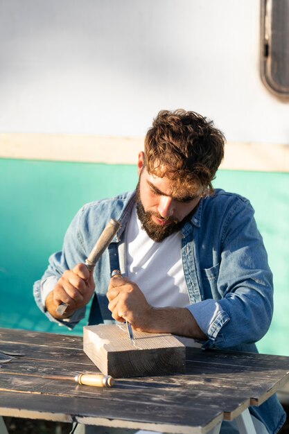 Young man engraving in wood