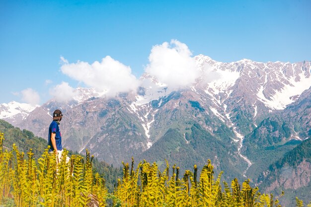 Young man enjoying the beautiful view of mountains