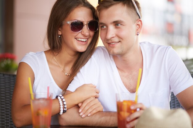 Young man enjoying a drink with his girlfriend