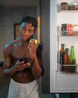 Free photo young man enjoying a snack at home in the middle of the night