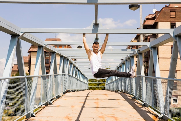 Young man exercising on the bridge