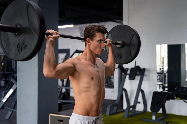 Young man exercising at the gym for bodybuilding