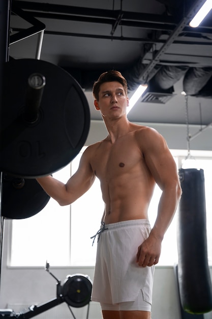 Young man exercising at the gym for bodybuilding