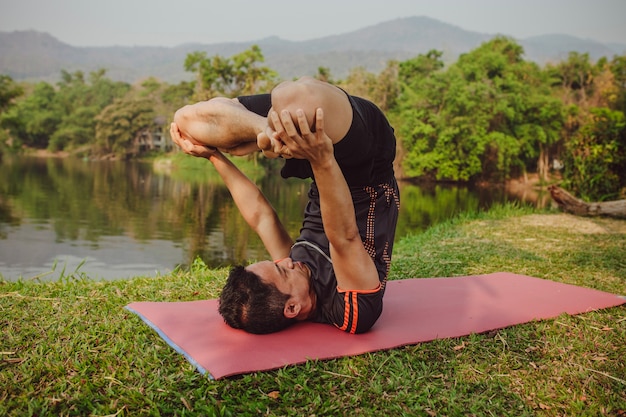 Young man at expert yoga pose