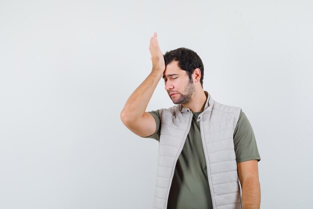 Young man feeling regret on white background