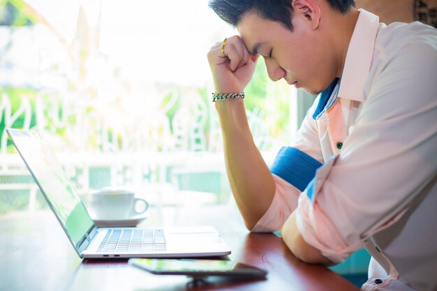 Young man feeling serious in cafe