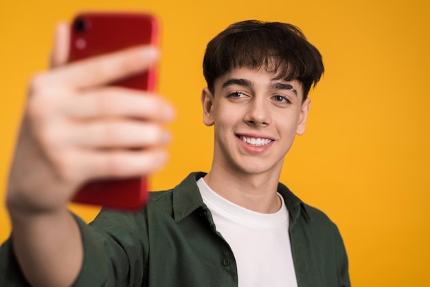 Young man filming himself on the phone