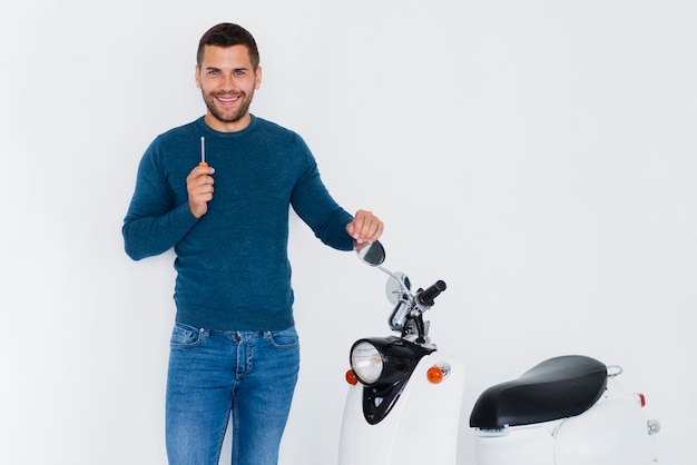 Young man fixing his motorcycle