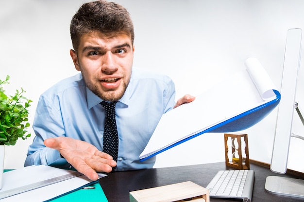 Young man getting upset and angry at the office