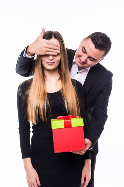 Young man and girl couple present gift close eyes with a hand