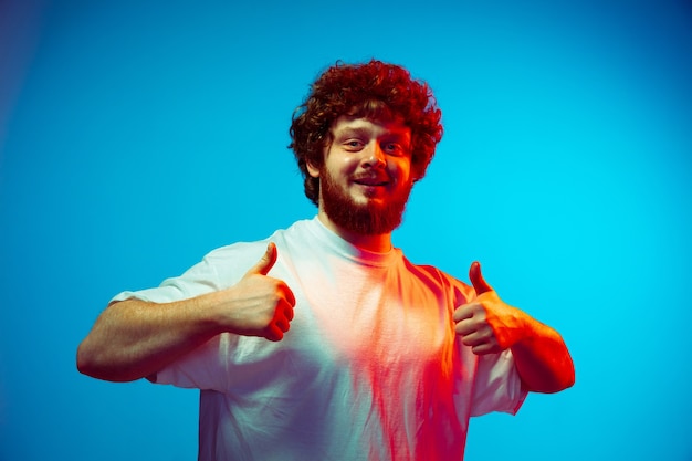 Young man giving thumbs up