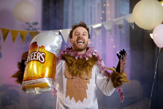 Young man having fun at costumes party