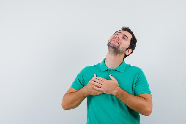 Young man having a heart attack on white background