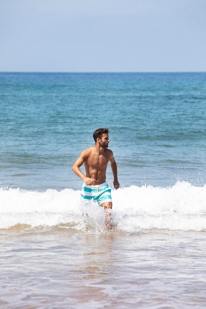 Young man having a roadtrip in cerca de playa laga