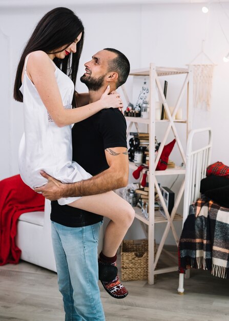 Young man holding attractive woman 