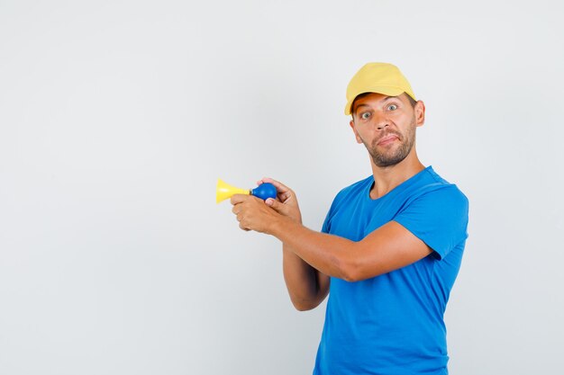 Young man holding bicycle signal in blue t-shirt