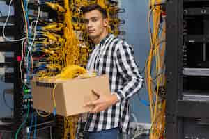 Free photo young man holding a box with wires