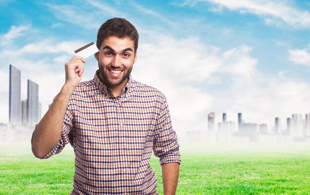 young man holding card in hand. 
