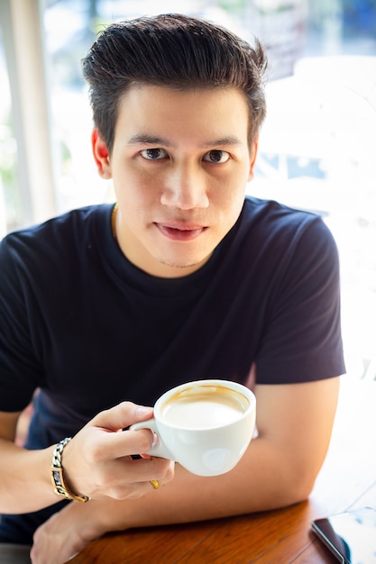 Young man holding a coffee cup